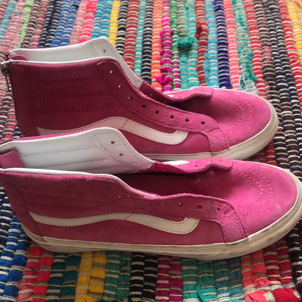 Pink high tops with zippers in the back.